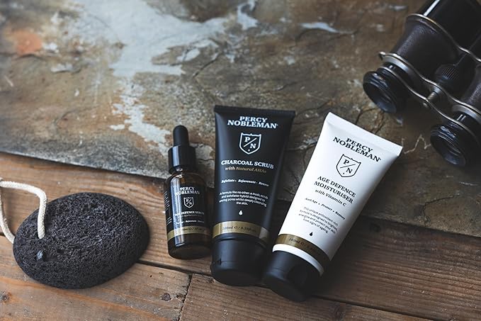 Age Defence Kit, a men's skincare set containing Charcoal Face Scrub (with Natural AHAs), ultra-hydrating Facial Serum (with Hyaluronic Acid), and Moisturiser (with Vitamin C)